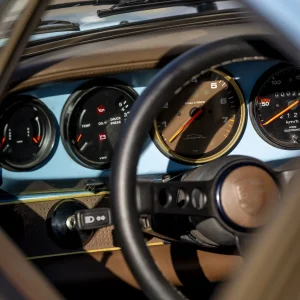 Classic car dashboard with analog gauges and steering wheel