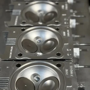 Three machined engine cylinder heads with valves